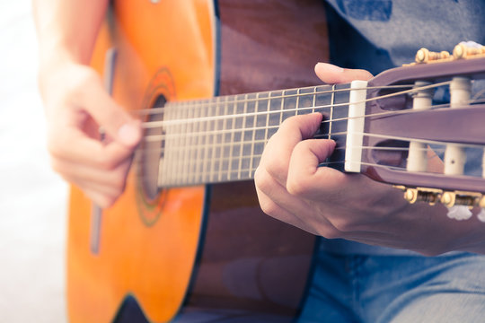  hand playing on  guitar