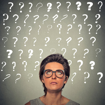 woman with puzzled face expression and question marks above her head