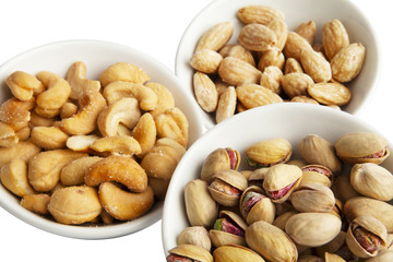 Pistachio, cashew and almond isolated on white.