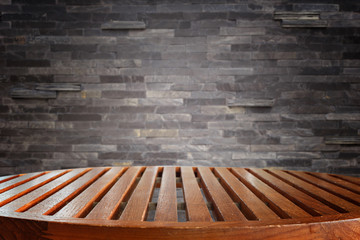 Empty top wooden table and stone wall background