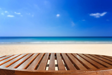 Empty top of wooden table and view of tropical beach