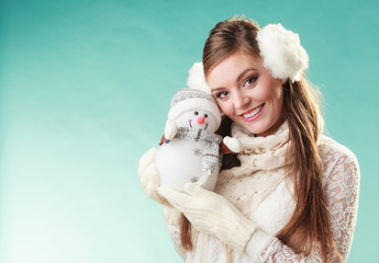 Obraz premium Smiling cute woman with little snowman. Winter.
