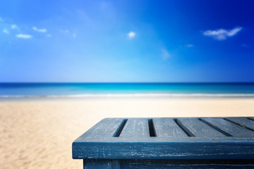 Empty top of wooden table and view of tropical beach