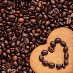 Heart shaped cookie on coffee beans background