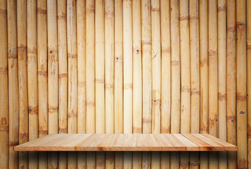 Empty top wooden shelves and bamboo wall background