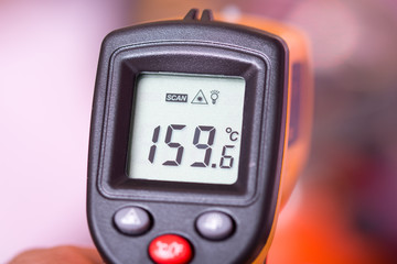 Yellow digital infra red thermometer. © zlajaphoto