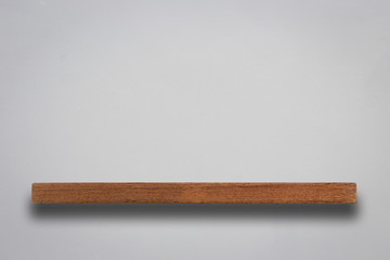 Empty wooden shelves and stone wall background