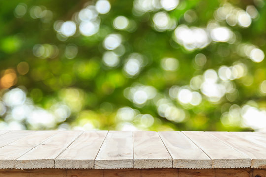 Empty top wooden table and sunny abstract blurred bokeh
