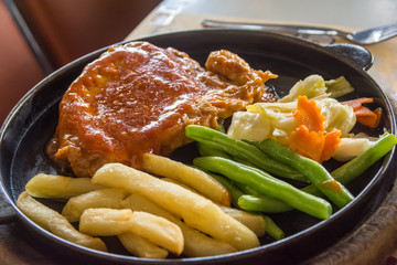 steak and chips on black plate