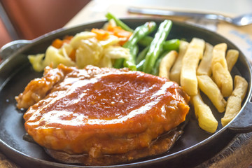 steak and chips on black plate
