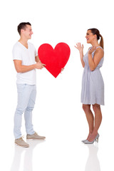 young man giving his girlfriend heart