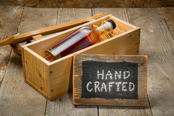 Hand crafted whisky bourbon rum spirit bottle in wooden gift package box 