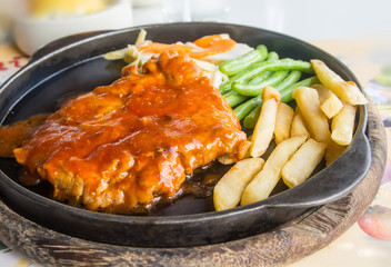 steak and chips on black plate