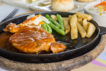 steak and chips on black plate