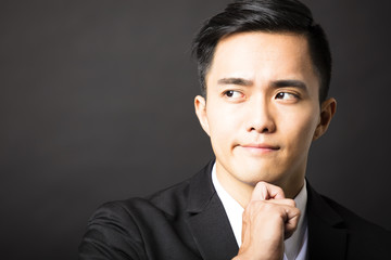 young man thinking and black background