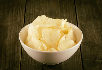 potato chips on wood - soft focus with vintage film filter