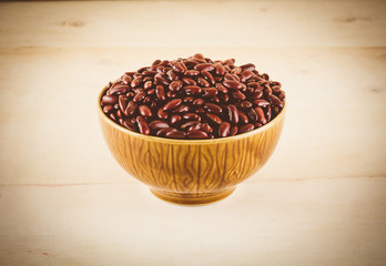 red  beans on wood background - soft focus with vintage film fil