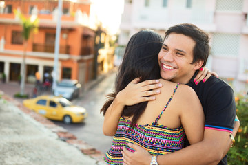 couple hugging in the streets of cartagena, colombia