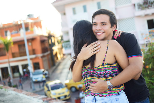 young couple hugging in the street of cartagenna, colombia.