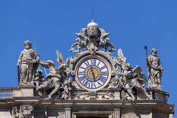 Fototapeta na wymiar Clock on the St. Peter's facade in Rome, Italy