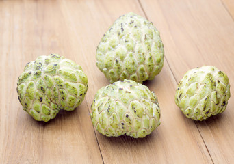 four custard apple on wooden board