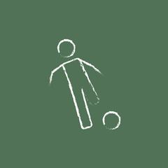 Soccer player with ball icon drawn in chalk.