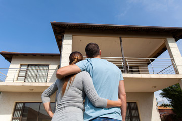 young couple looking at their new house - Powered by Adobe
