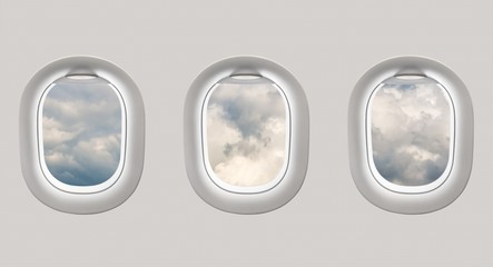 Looking out the windows of a plane to a clouds