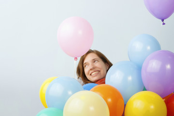 Fototapeta na wymiar Woman Surrounded by Balloons