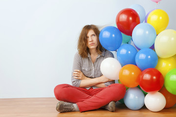 Annoyed Woman Holding Balloons