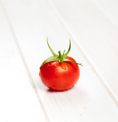 red tomatoe on wooden table