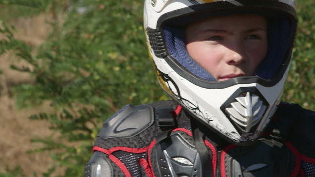 Face of young enduro racer in motorcycle protective gear closeup