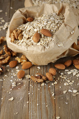 Fototapeta na wymiar Oatmeal with nuts in paper bag