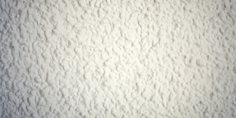 Concrete wall painted white. Closeup for backdrop.