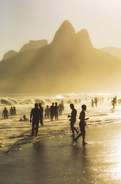 Ipanema Beach in Rio de Janeiro Brazil with Two Brothers Dois Irmaos Mountain sunset silhouettes