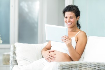 Happy woman video chatting on tablet