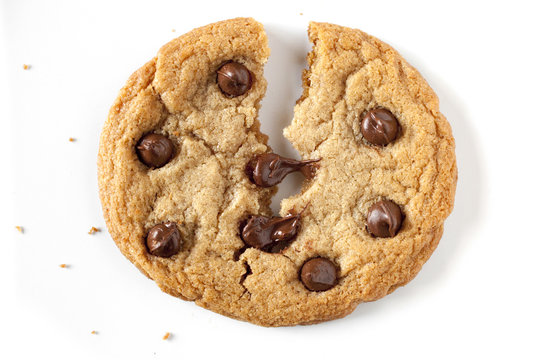 chocolate chip cookie being split in the middle, chocolate chip is melting.