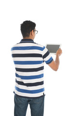 Happy young man using digital tablet against white background.