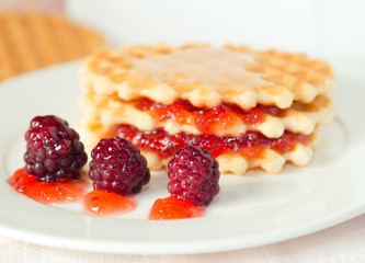 Golden waffles with raspberries and jam