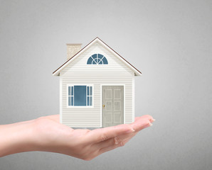 holding house representing home ownership