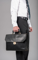 Businessman standing and holding a briefcase