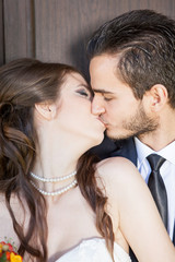 Bride and groom kissing each other