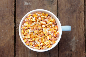 Corn grains on wooden table