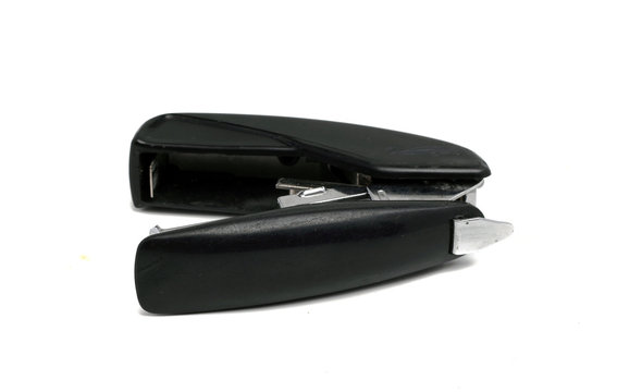 old dusty black office stapler on a white background