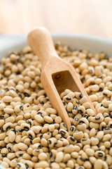 uncooked beans and wooden scoop