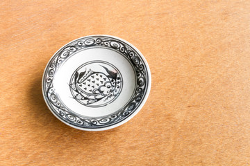 Old dish on wooden background