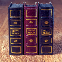 Vintage old books on wooden deck tabletop against grunge wall