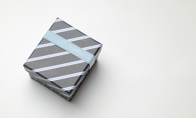 Black gift box with ribbon and blue lines Top perspective