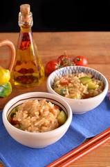 bowls of rice with cherry tomatoes and zucchini with chili oil