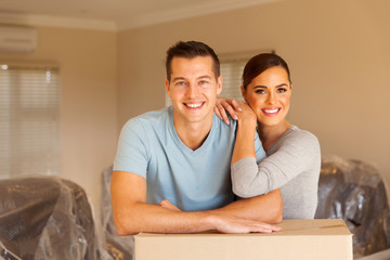couple leaning on boxes in new home